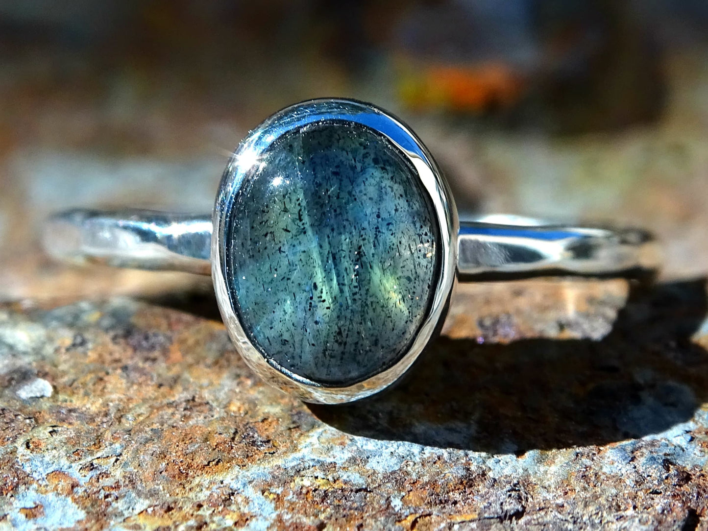 silver oval labradorite ring with hammered sterling silver band and closed bezel setting