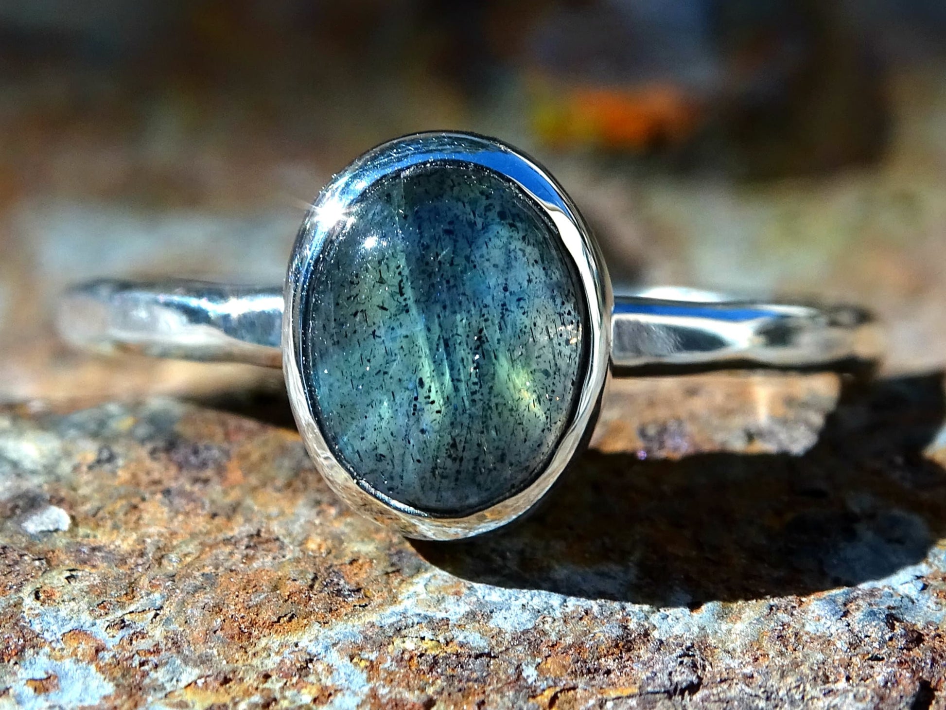 silver oval labradorite ring with hammered sterling silver band and closed bezel setting