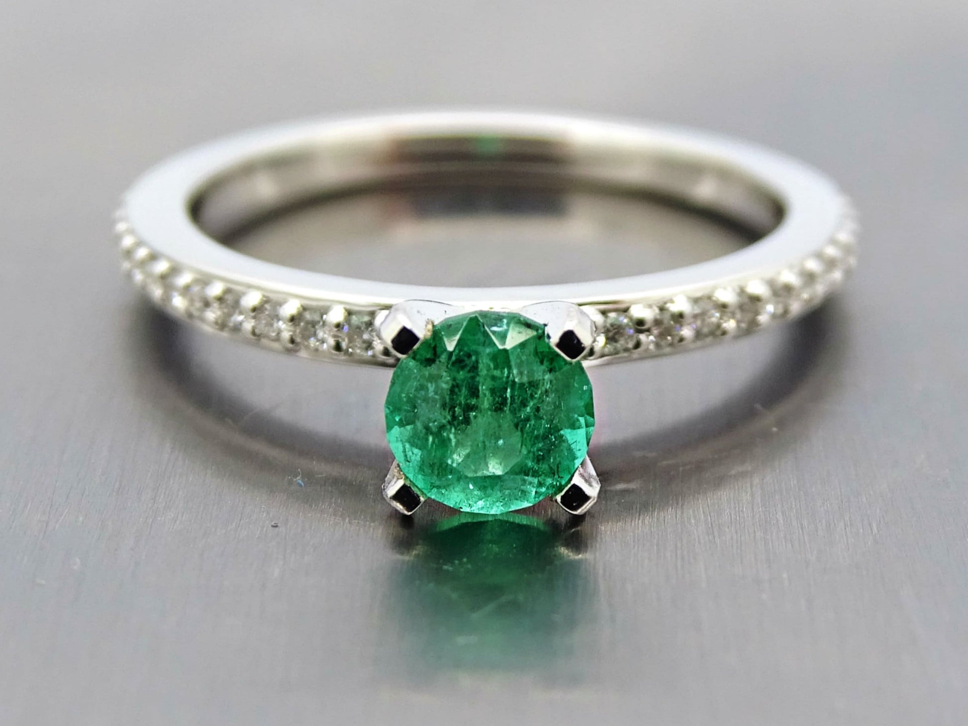 14k white gold emerald engagement ring with round faceted Colombian emerald and diamond-studded band