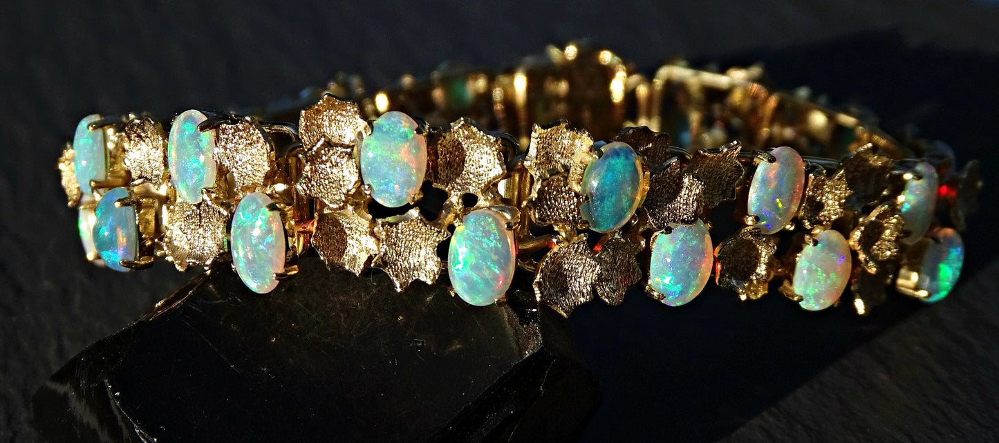 luxurious 14k and 18k gold opal bracelet with 28 Australian crystal opal gemstones showing rainbow colors