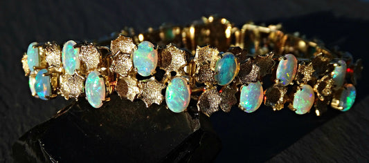 luxurious 14k and 18k gold opal bracelet with 28 Australian crystal opal gemstones showing rainbow colors