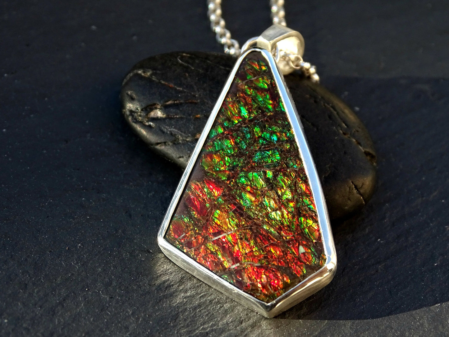 Large Ammolite gemstone pendant with vibrant red and green dragon skin pattern set in sterling silver with chain
