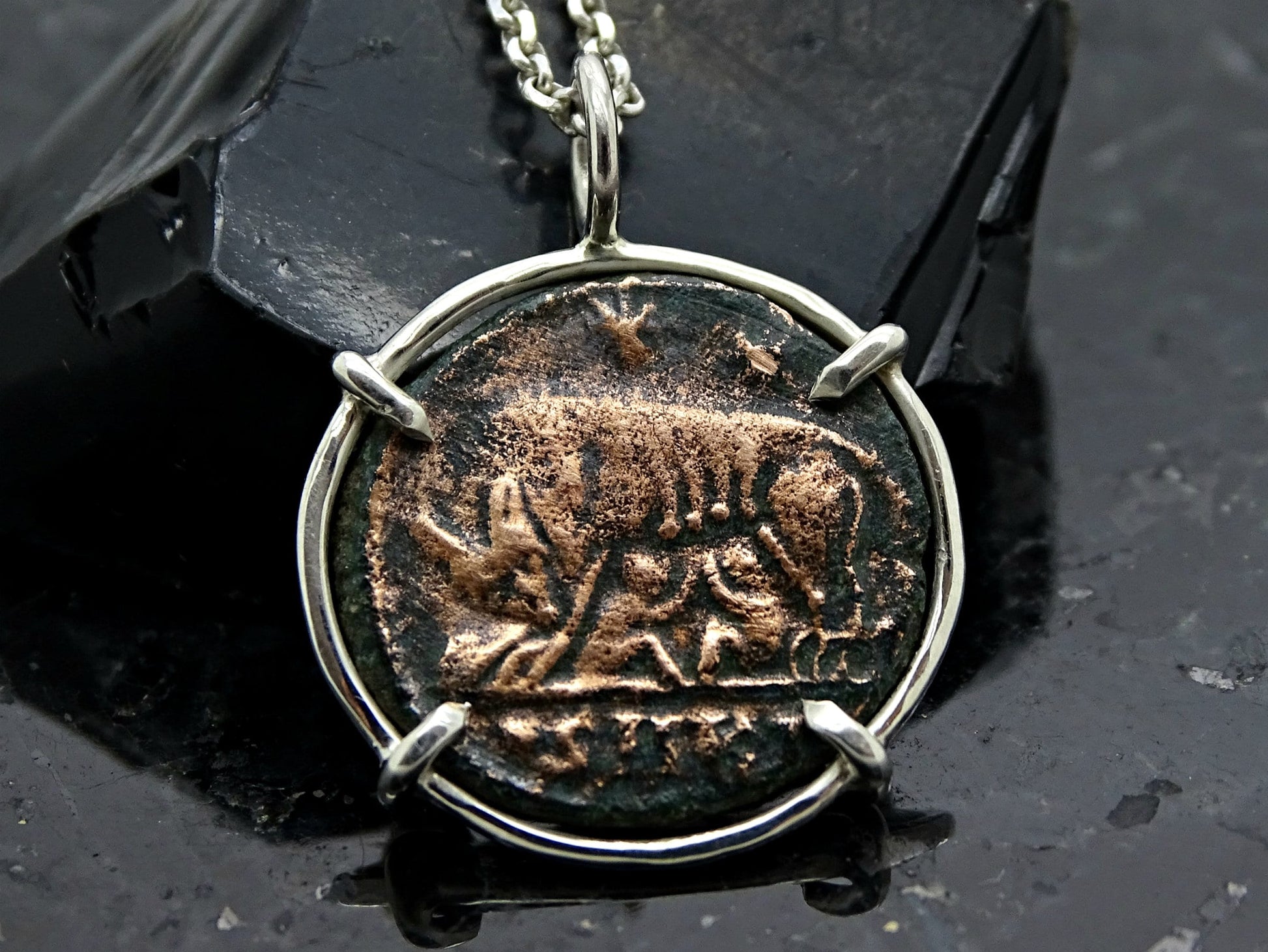Ancient she-wolf coin pendant set in sterling silver necklace with four-prong setting on silver chain