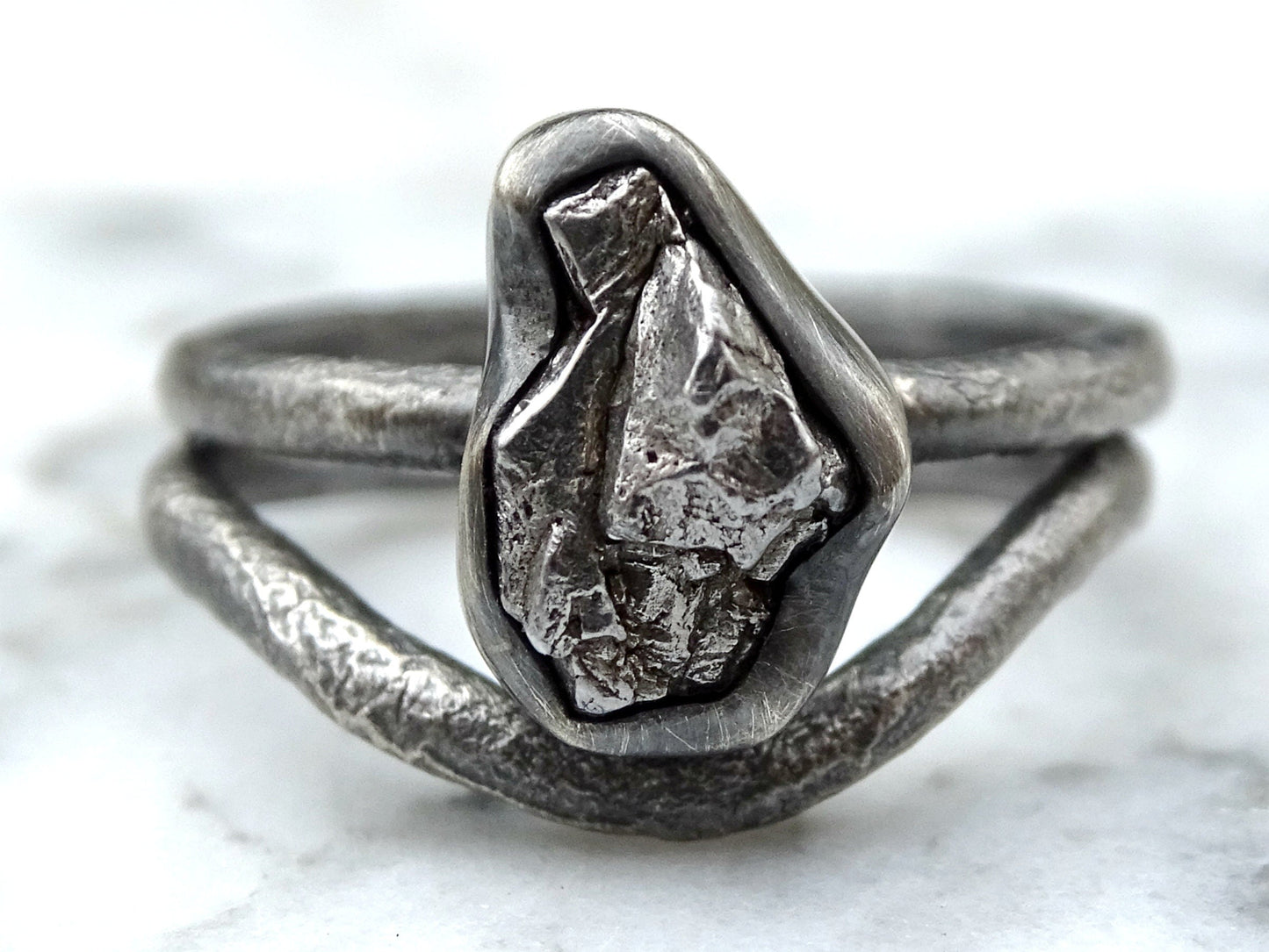 Meteorite engagement ring with irregular Campo del Cielo iron meteorite set in molten sterling silver band