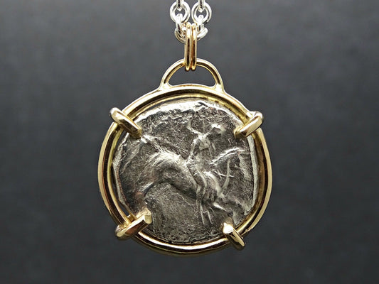 14k gold pendant featuring an authentic ancient silver coin from Calabria Tarentum with a boy on horseback design