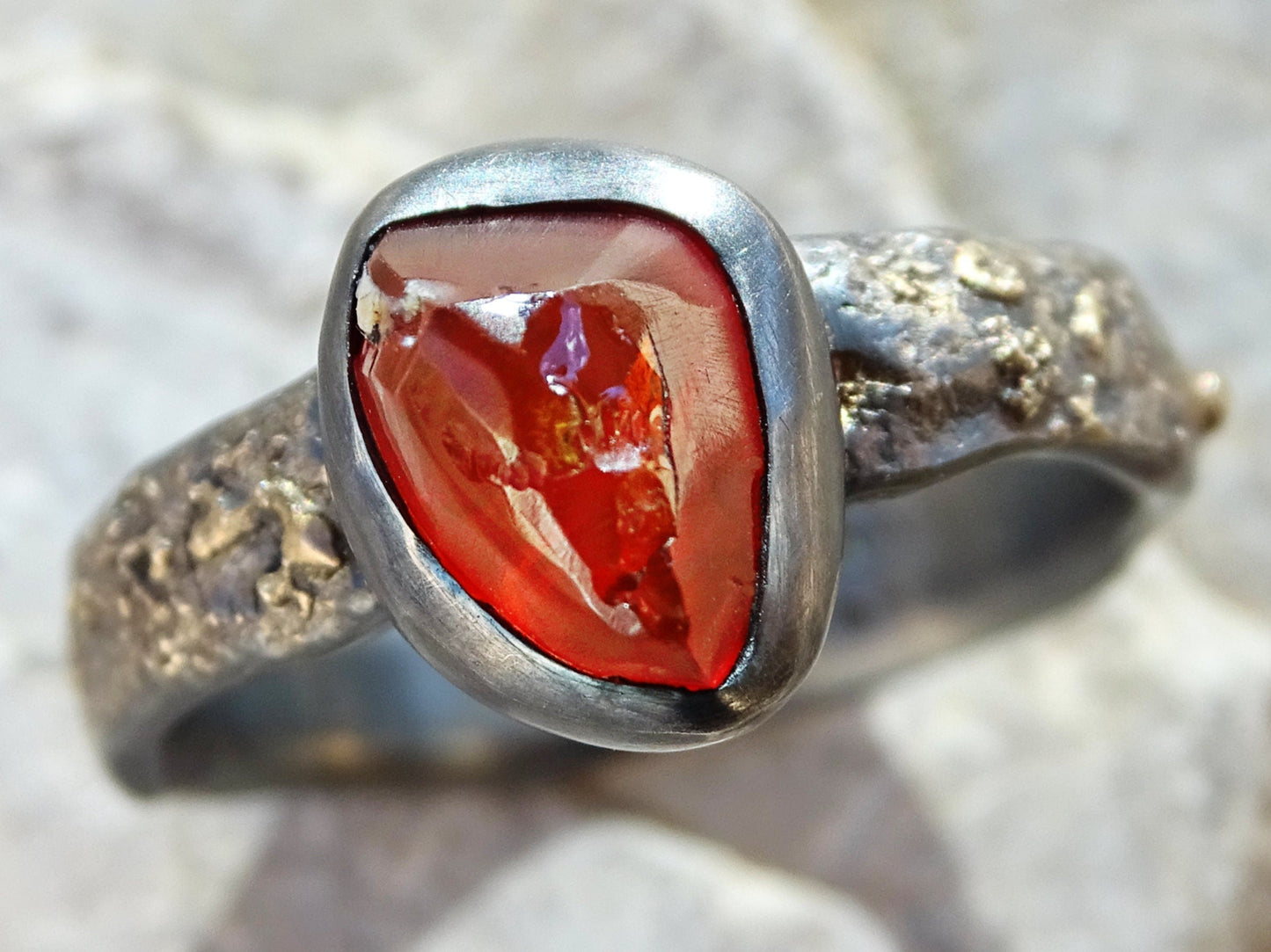 Raw fire opal ring with 14k yellow gold molten textured silver band and closed bezel setting