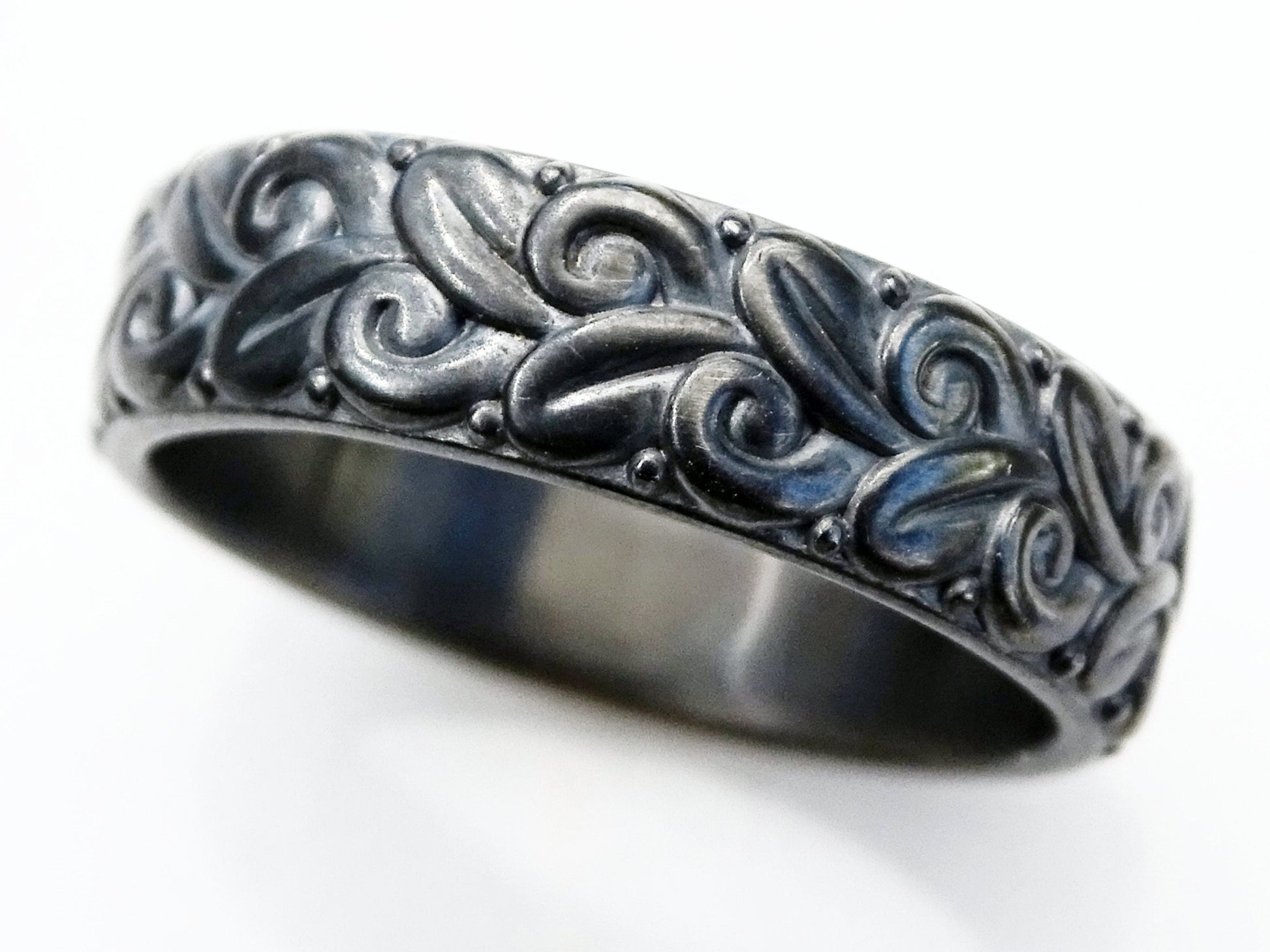 Black oxidized sterling silver wedding ring with floral nature-inspired sculptural design and textured relief pattern