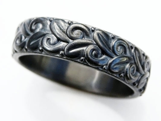 Black oxidized sterling silver wedding ring with floral nature-inspired sculptural design and textured relief pattern