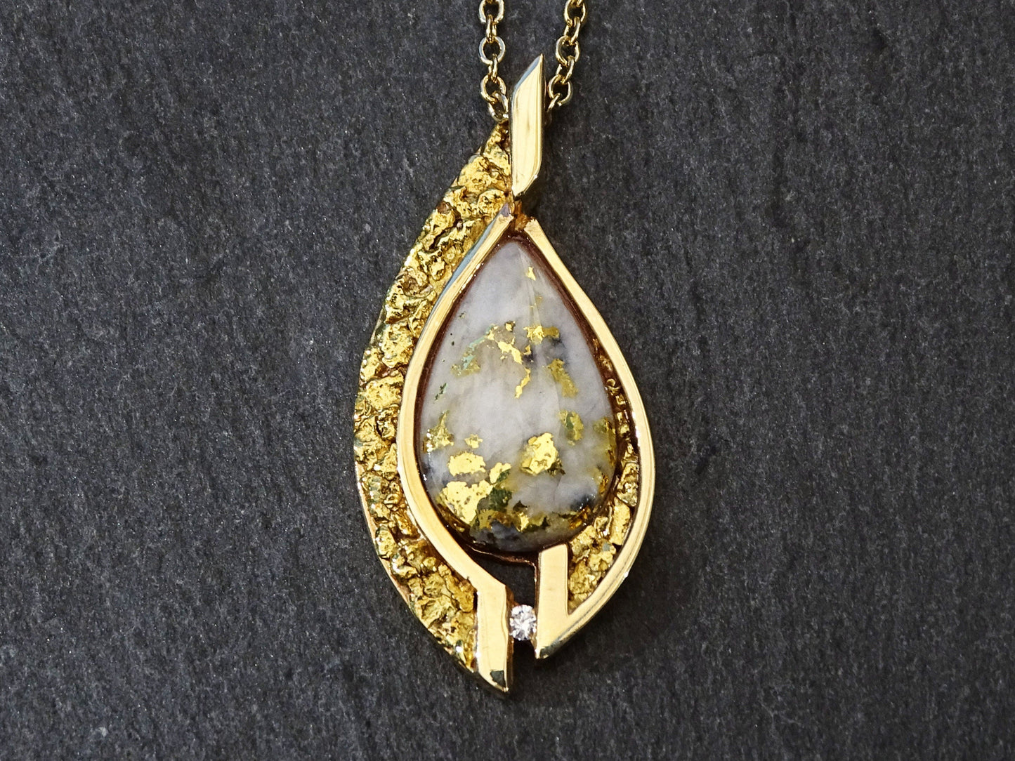 14k yellow gold pendant with gold in quartz cabochon and 22k Yukon gold nuggets on black background