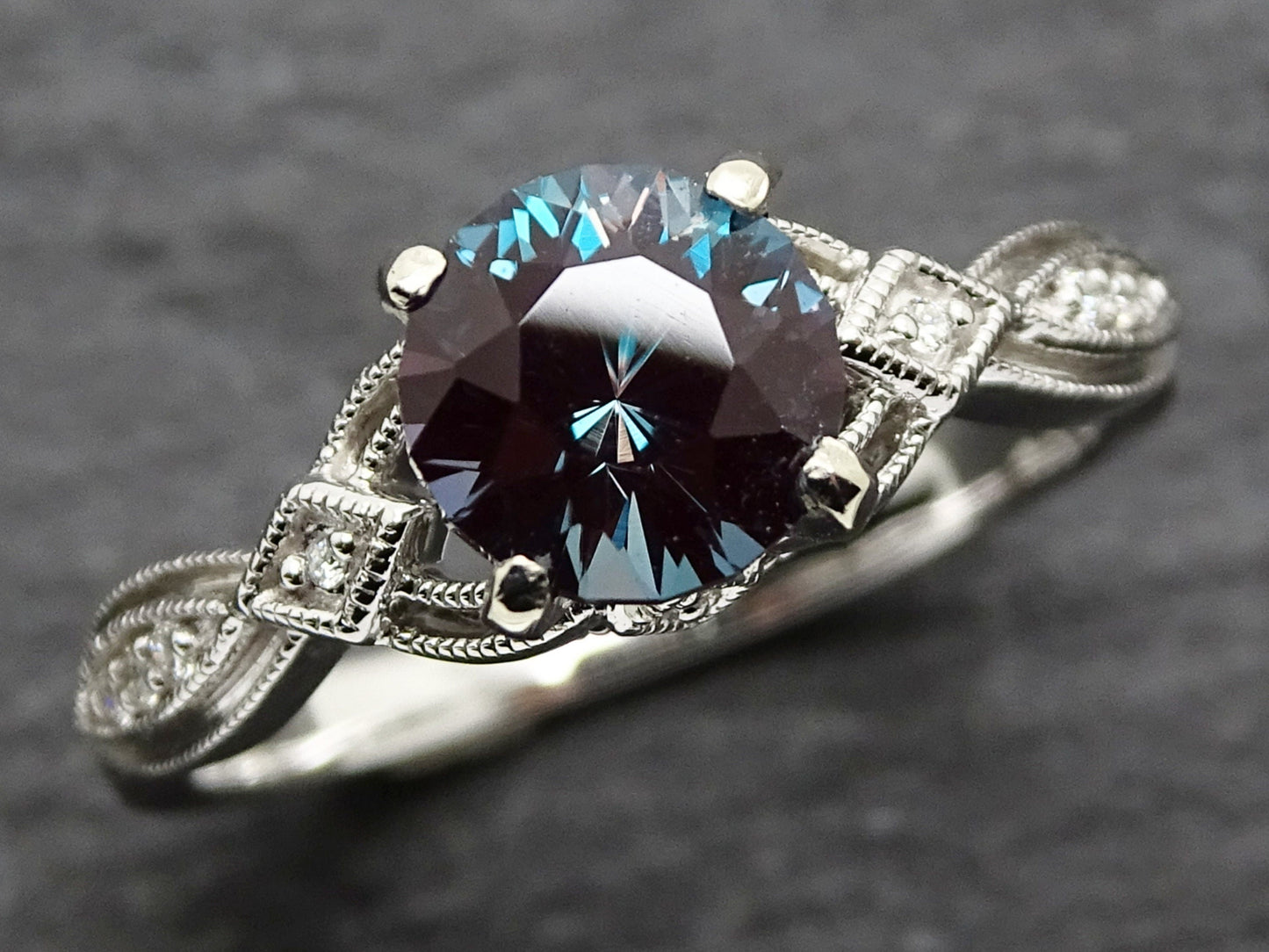14k white gold alexandrite ring with color-change center stone and diamond-accented Art Deco band