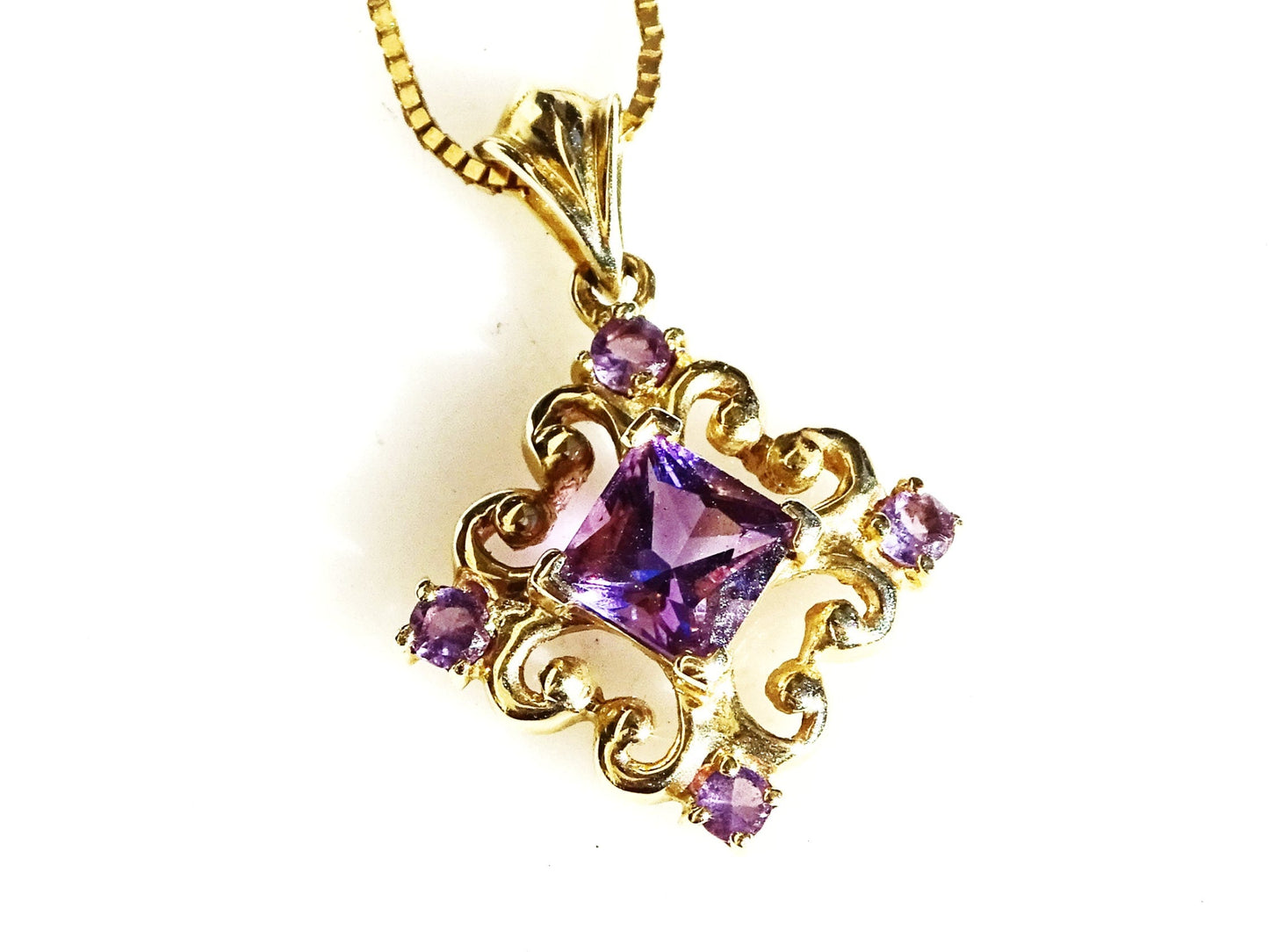 14k gold filigree amethyst pendant with princess cut center stone and four round amethysts on a gold chain