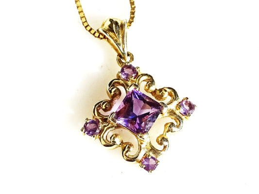 14k gold filigree amethyst pendant with princess cut center stone and four round amethysts on a gold chain