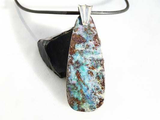 Large rainbow Australian boulder opal pendant with sterling silver bail on black neoprene cord