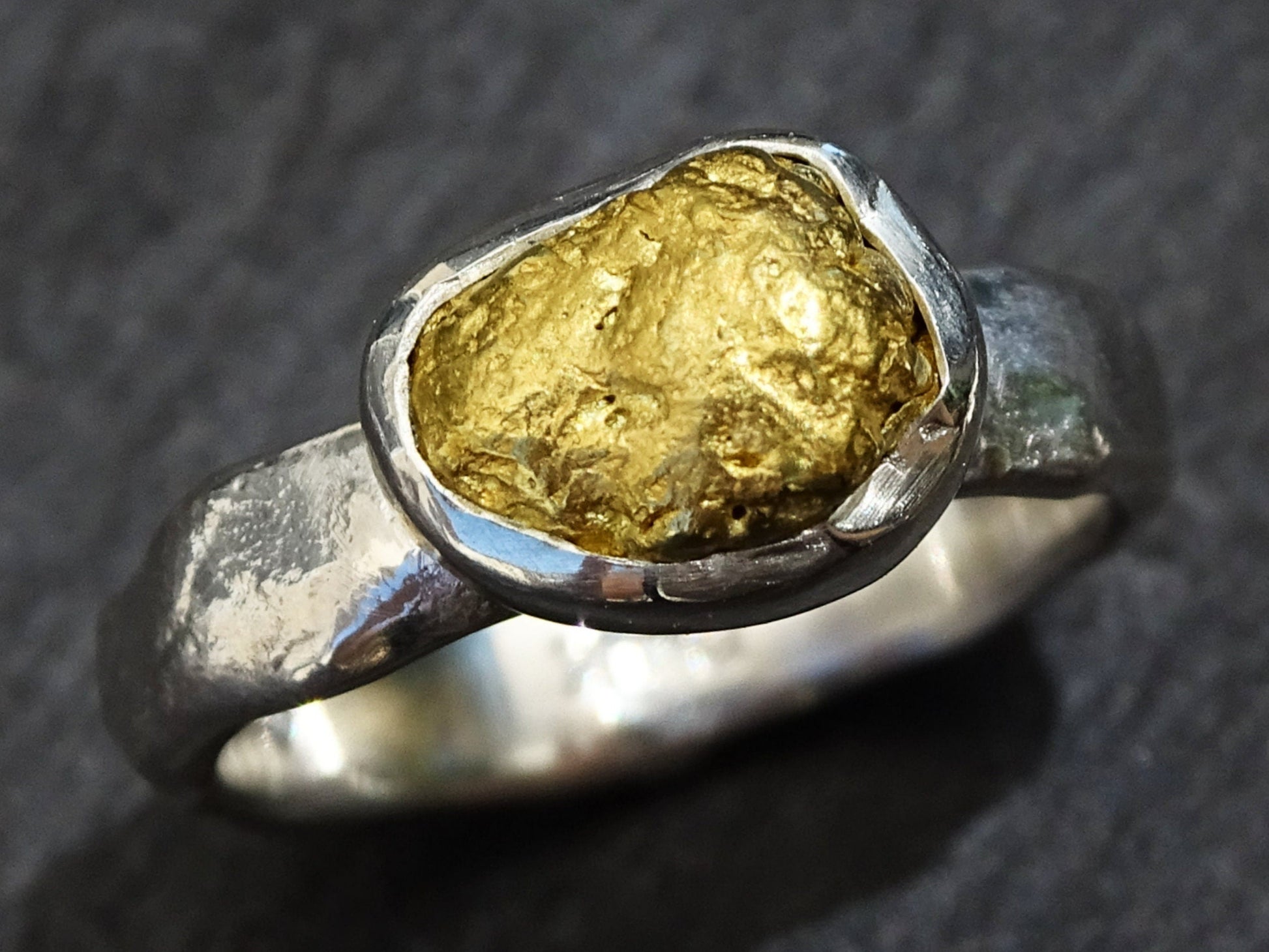 handmade gold nugget ring with a fine silver band and natural Yukon gold nugget centerpiece