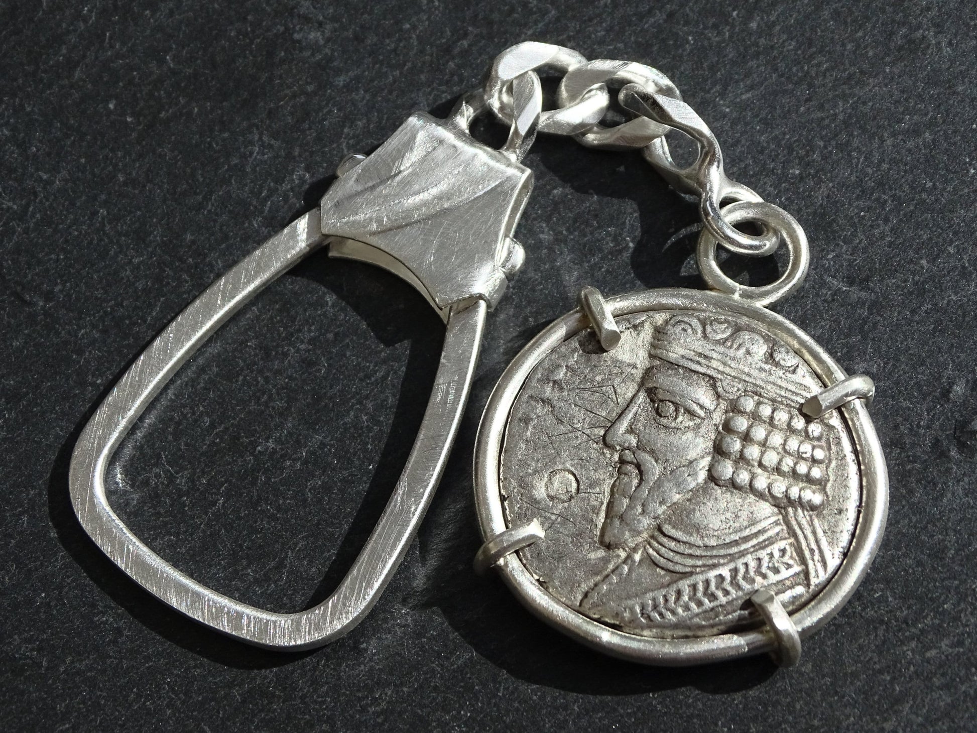 sterling silver keychain featuring an ancient Parthian coin with diademed bust of Gotarzes II in a four-prong matte silver setting