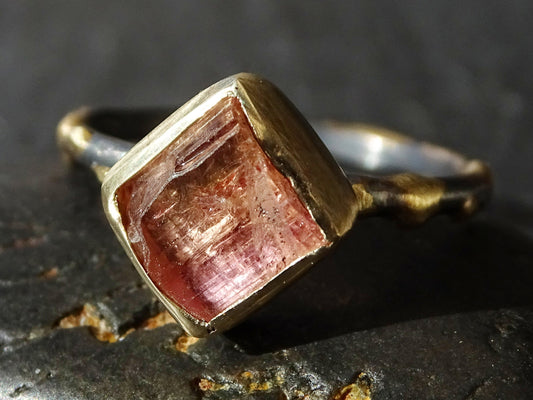 Pink Imperial Topaz ring with rough pink and gold crystal in 14k gold bezel setting and darkened silver band