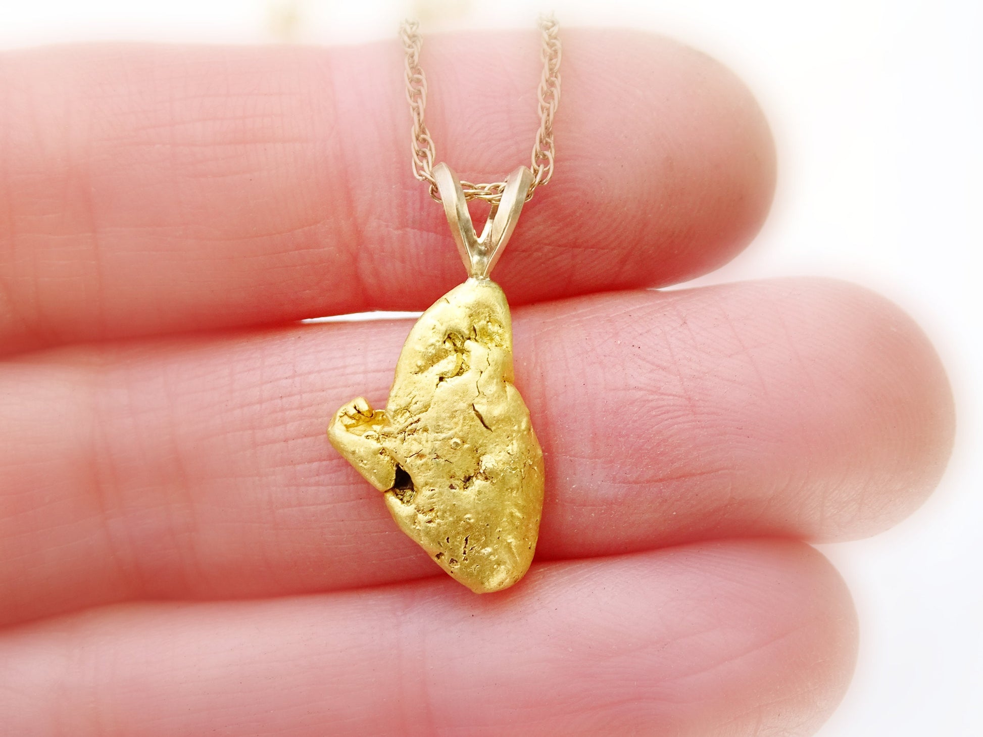 Real gold nugget pendant from Alaska.
> overall pendant length is 24.5mm (0.96 inches) including the bail, weighing a total of 5.05 grams > all natural gold nu