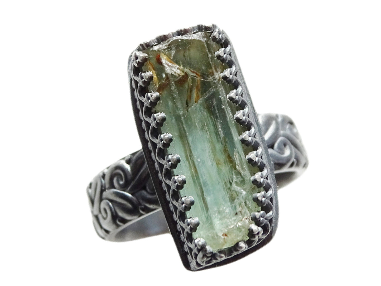Raw green aquamarine engagement ring with sculpted black oxidized silver band