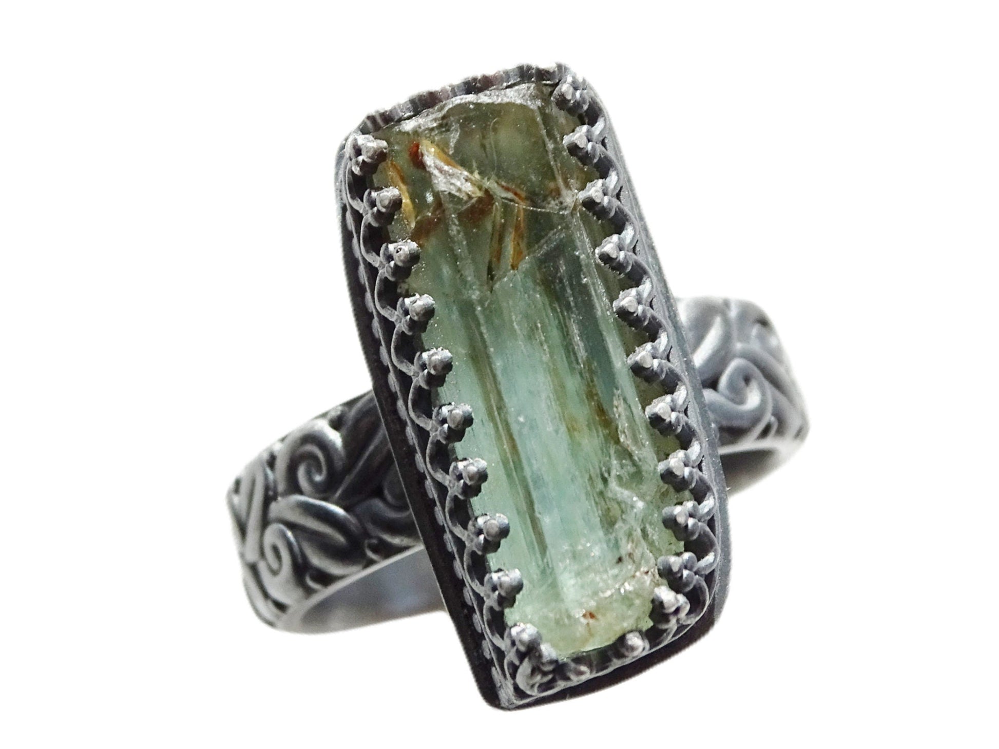 Raw green aquamarine engagement ring with sculpted black oxidized silver band