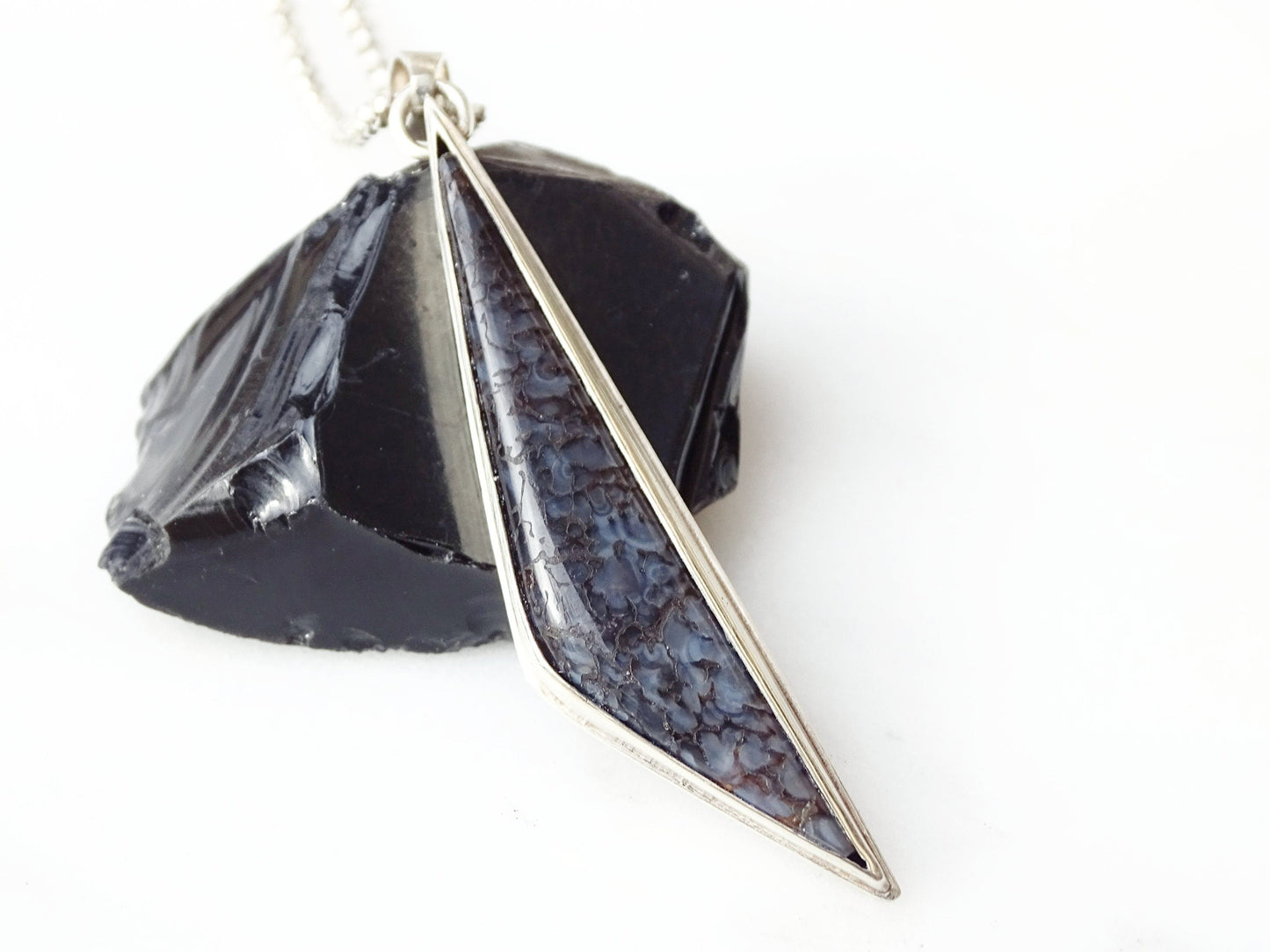 blue agatized dinosaur bone necklace pendant with sterling silver chain and spiderweb pattern