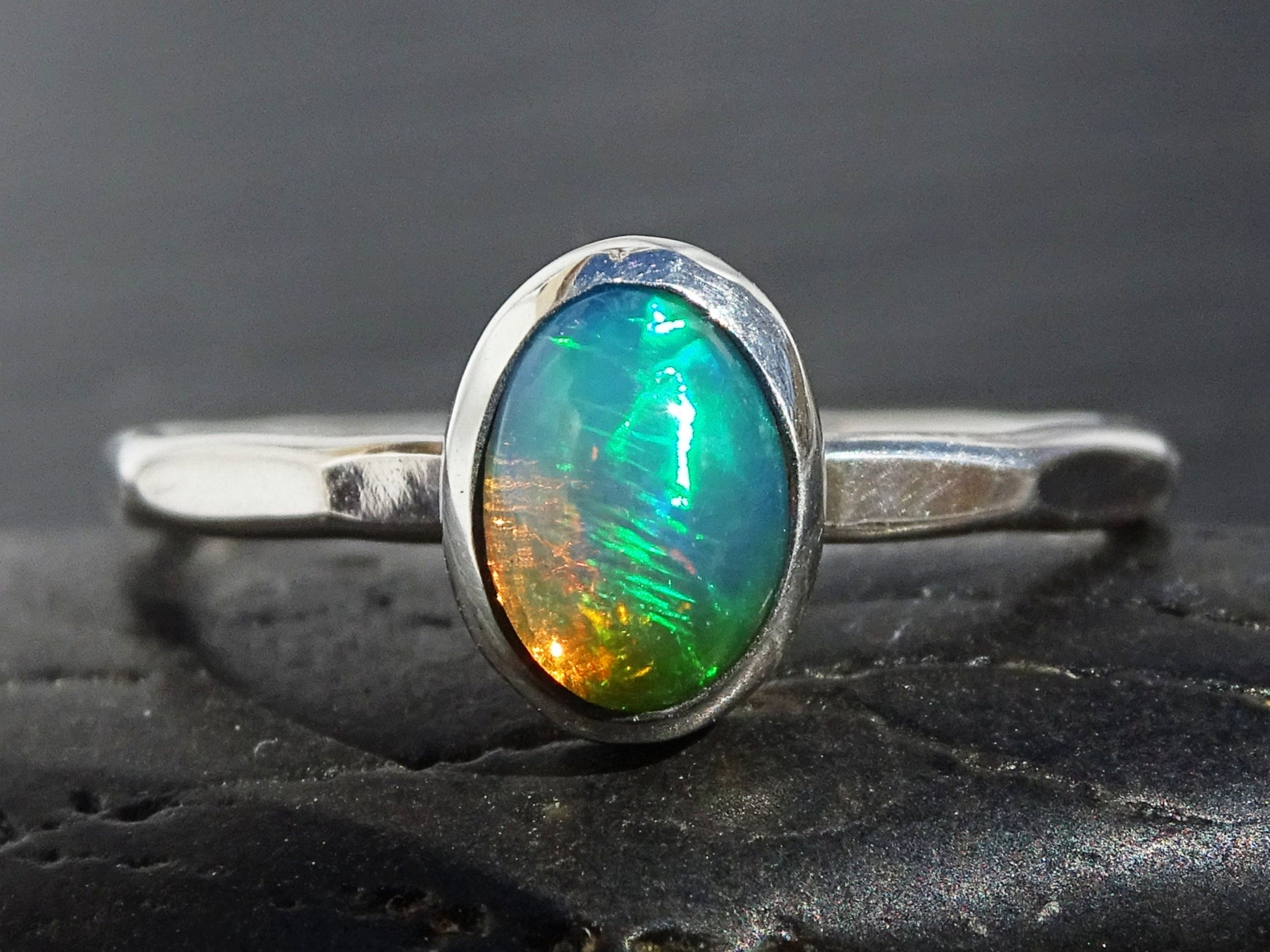 Sterling silver hammered band opal ring with genuine Welo opal gemstone in bezel setting