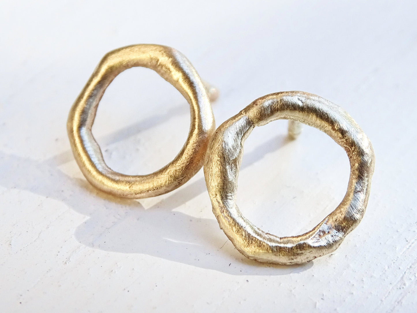 mismatched molten 14k gold stud earrings with organic round shape and rustic texture