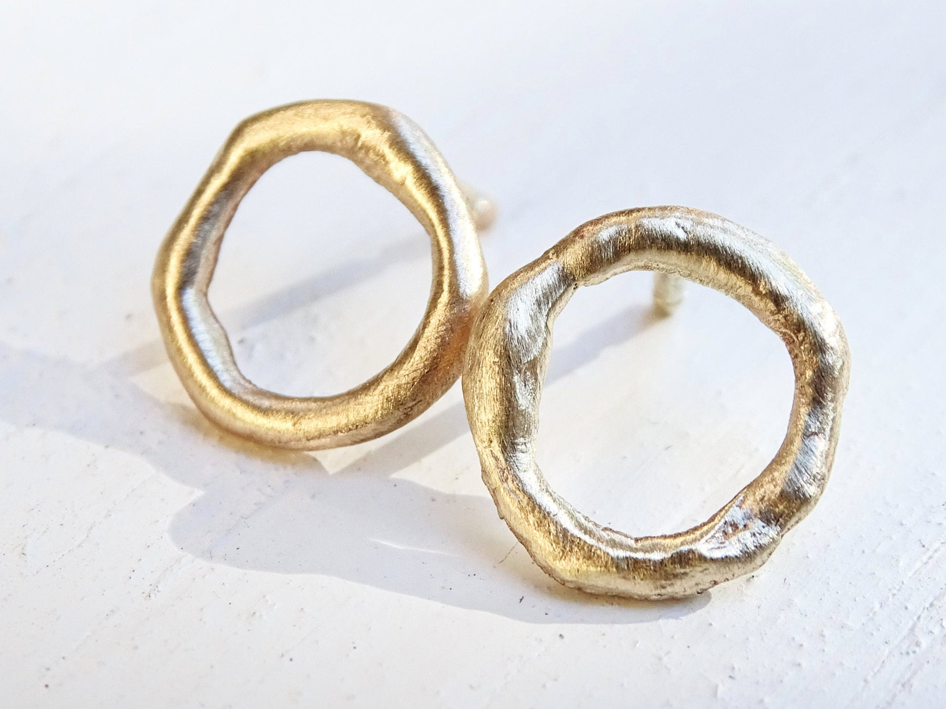 mismatched molten 14k gold stud earrings with organic round shape and rustic texture