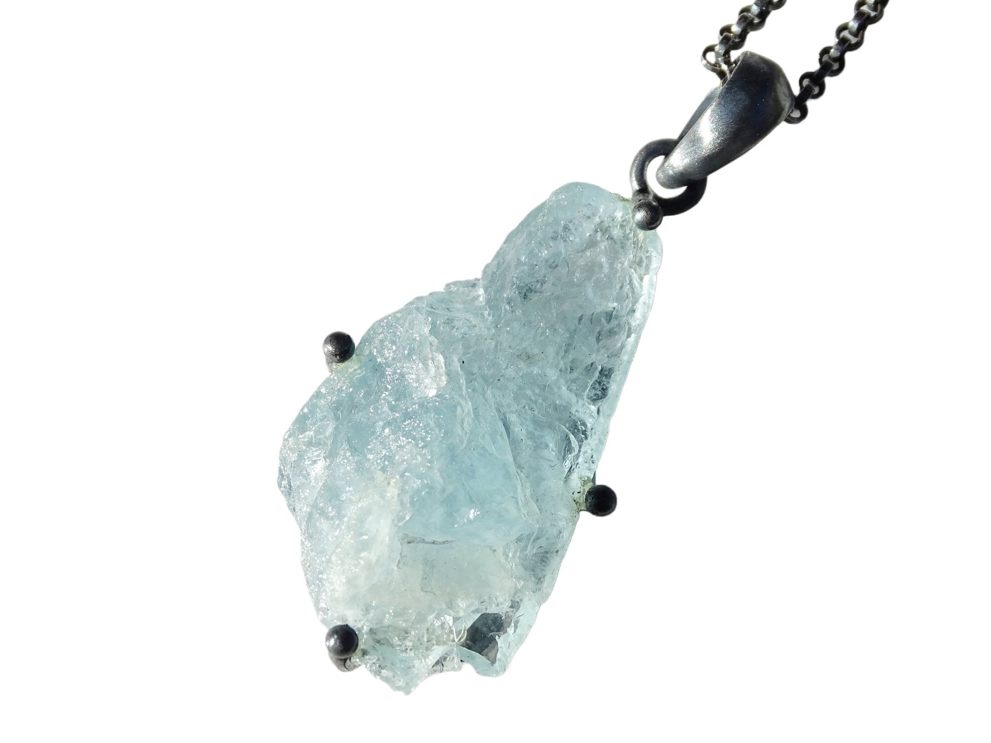 Raw uncut aquamarine stone pendant set in black sterling silver with chain