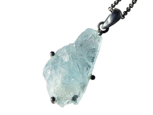 Raw uncut aquamarine stone pendant set in black sterling silver with chain