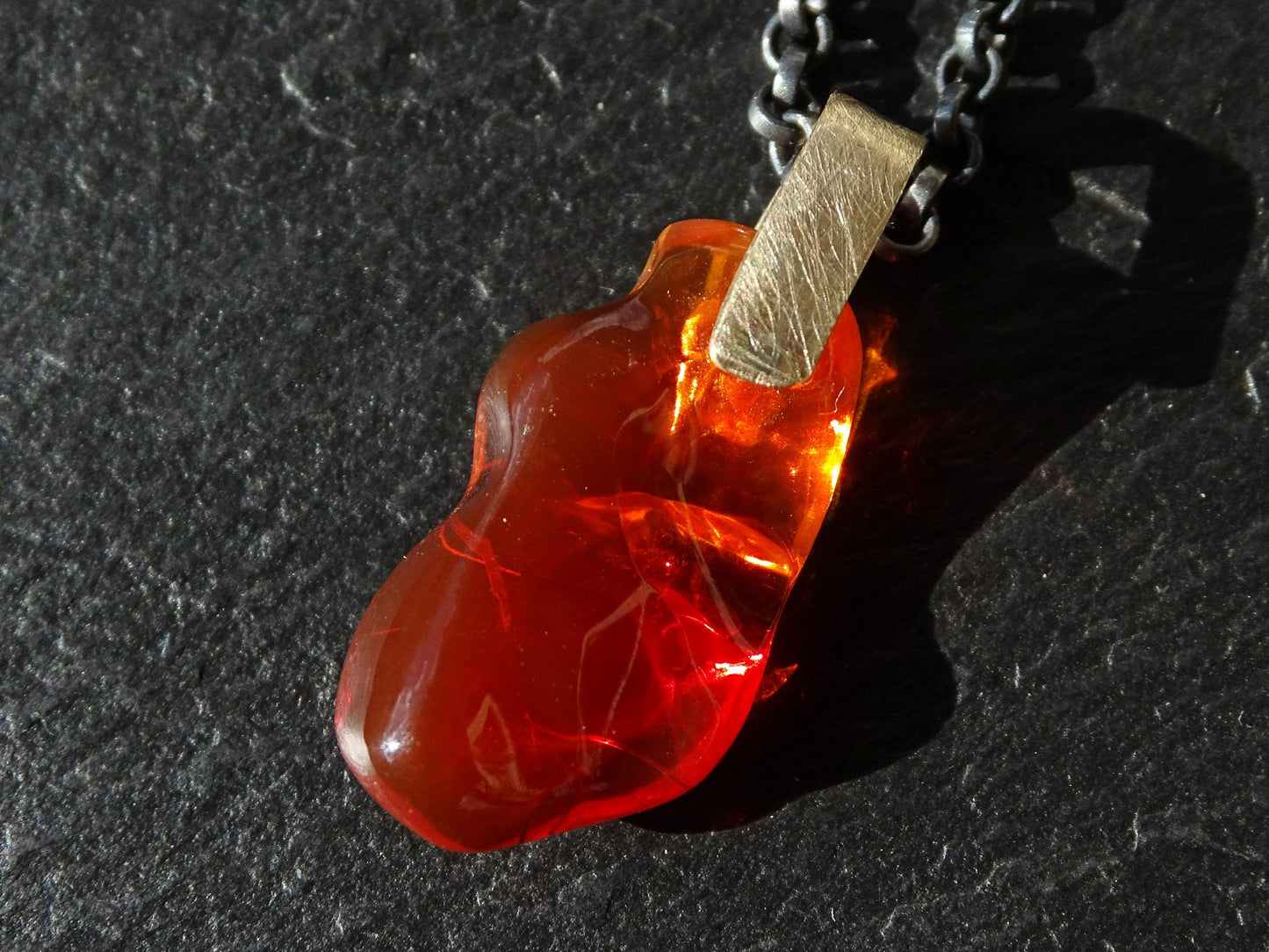 carved red fire opal pendant with solid 14k gold bail on black sterling silver chain