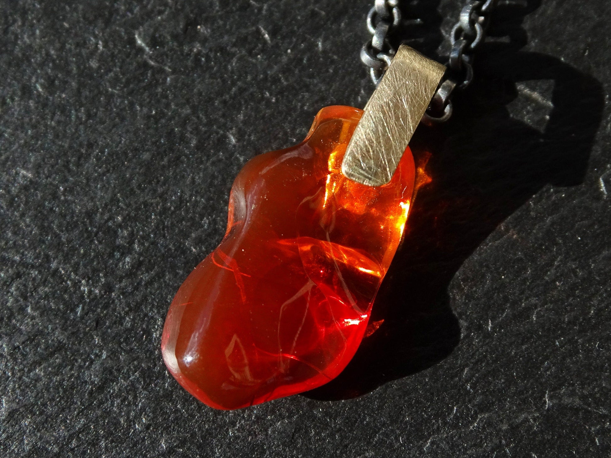 carved red fire opal pendant with solid 14k gold bail on black sterling silver chain