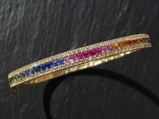 14k gold bracelet with rainbow princess cut sapphires and channel-set diamonds in a slim bangle design
