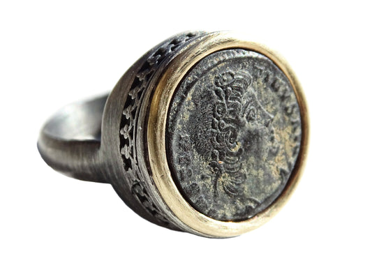 Ancient coin ring with authentic Roman bronze coin set in 14k gold bezel and black oxidized sterling silver band.