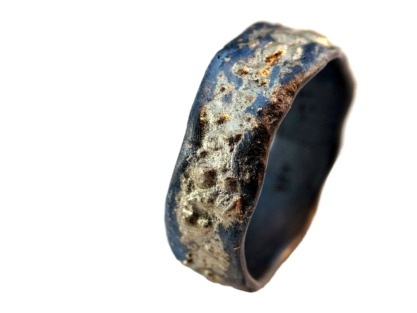 Molten lava ring with gold and silver band, textured surface.