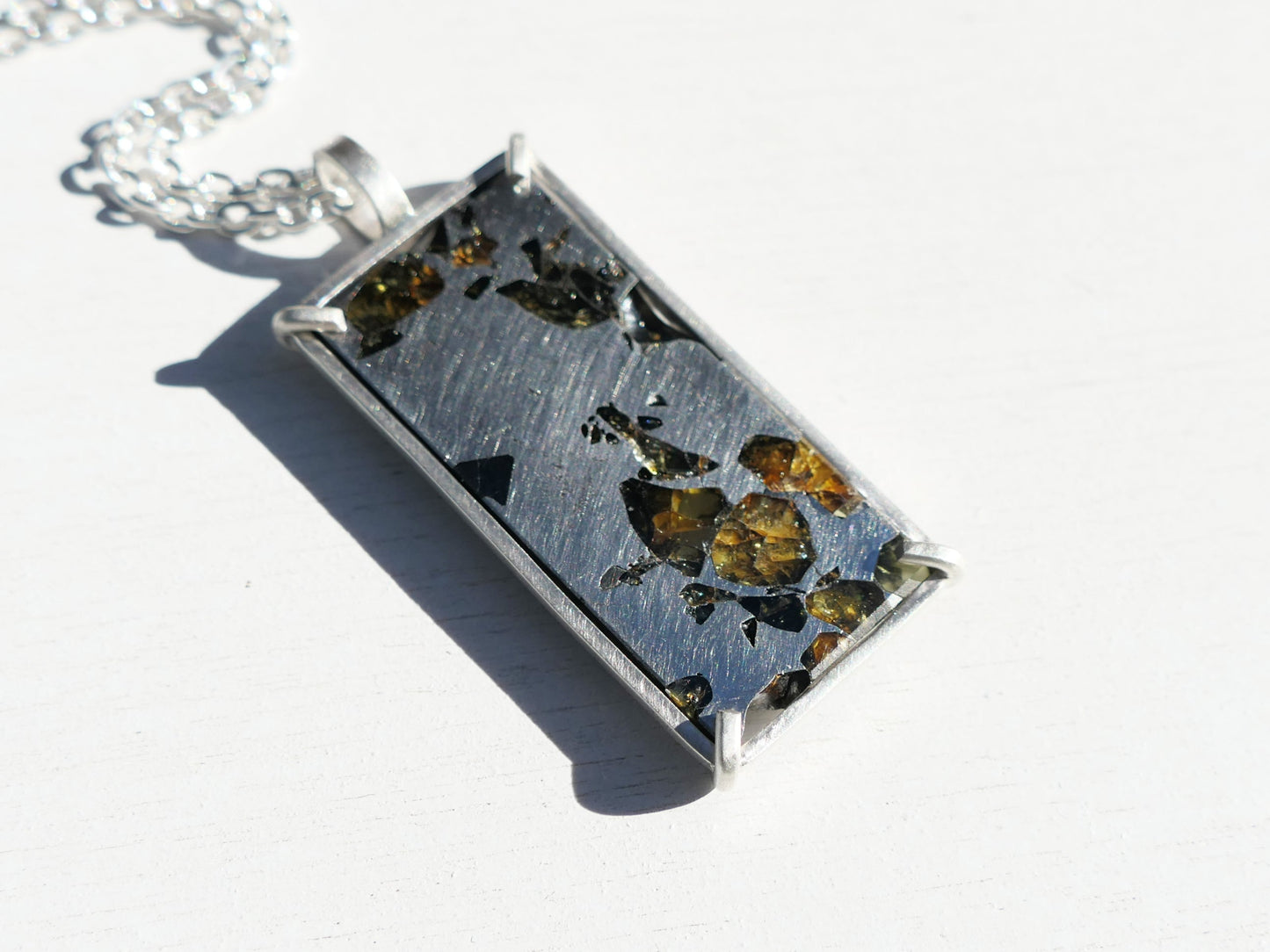 Sterling silver Pallasite meteorite pendant with diamond accents on a Seymchan necklace