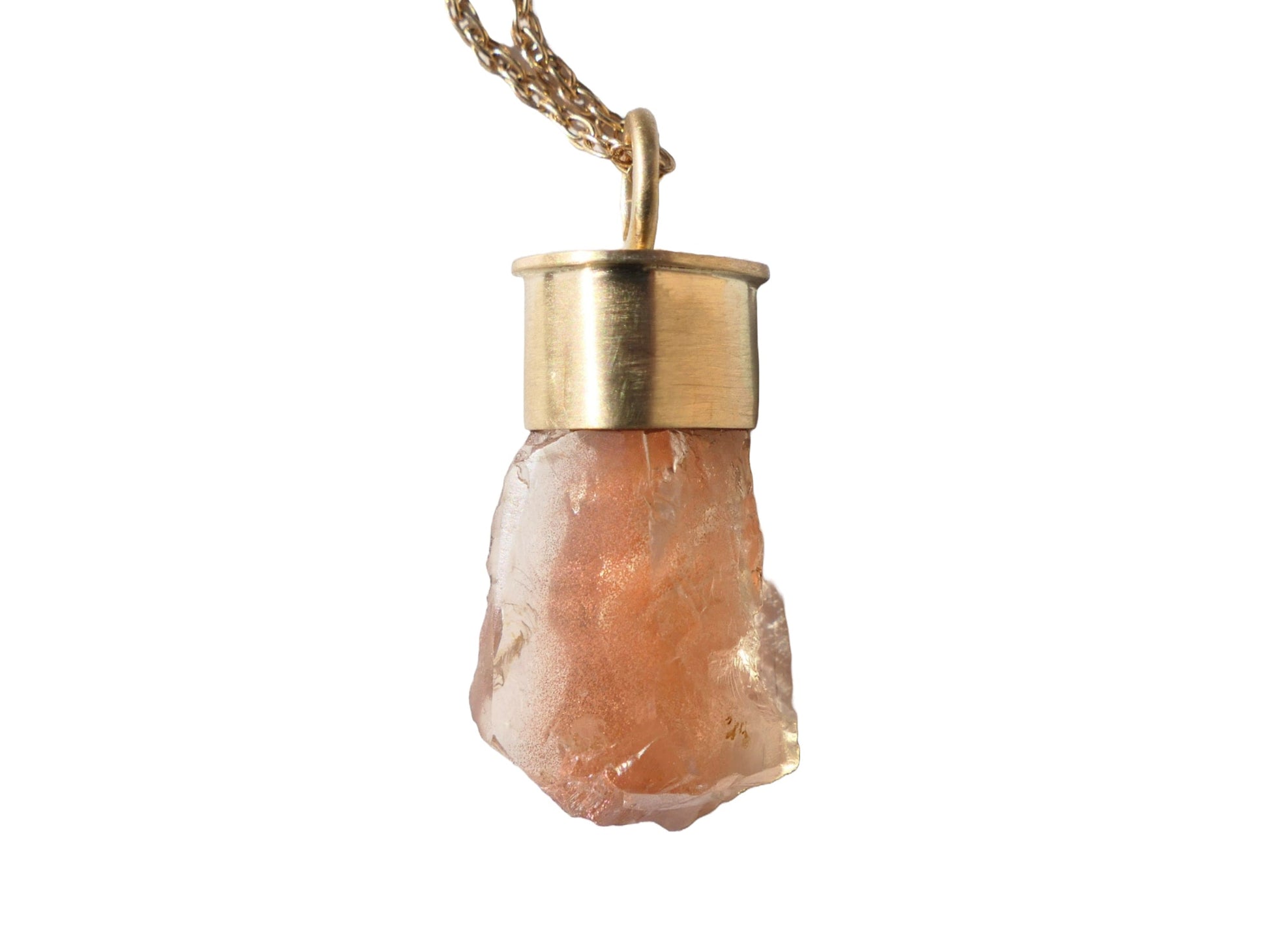 Raw Oregon sunstone pendant in 14k gold setting with peach schiller.