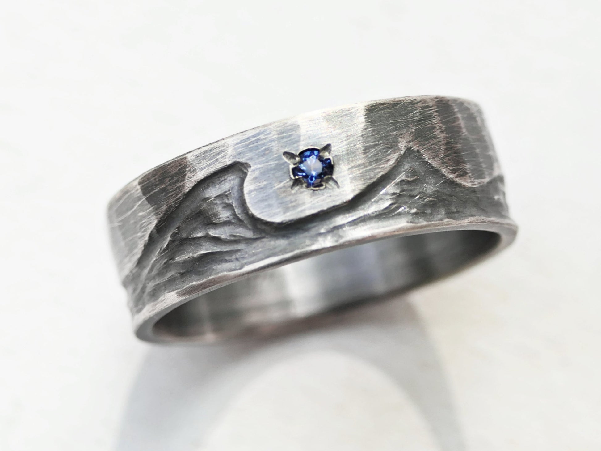 Unique Silver wave ring with small blue gemstone