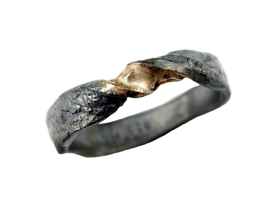 Rustic infinity ring with sterling silver and gold accents, black oxidized finish, and twisted Moebius design.