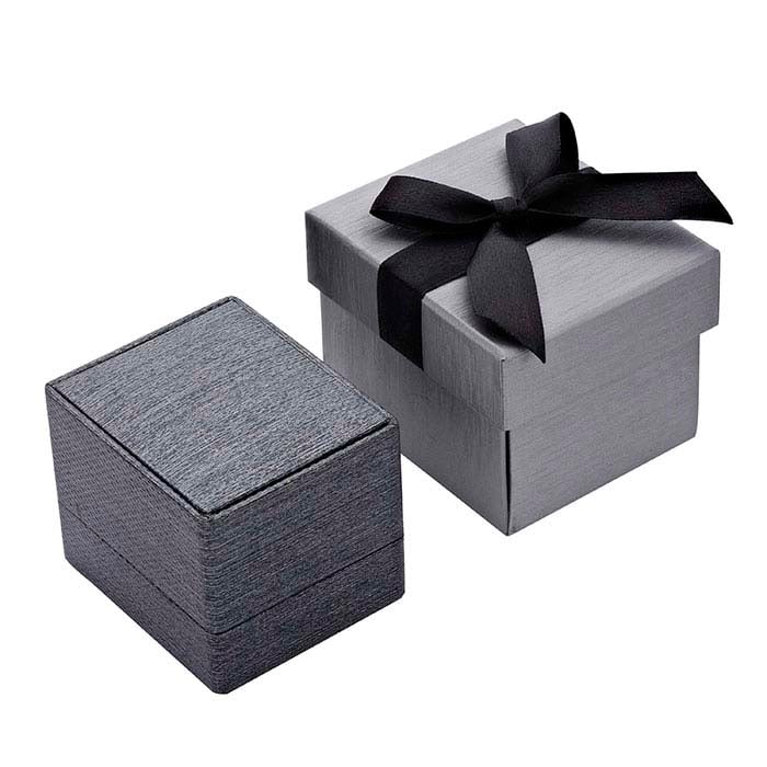 Gift wrap option with metallic grey boxes, one textured and one topped with a black satin bow.