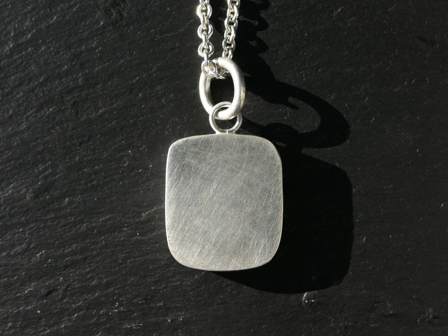 engraved turquoise pendant