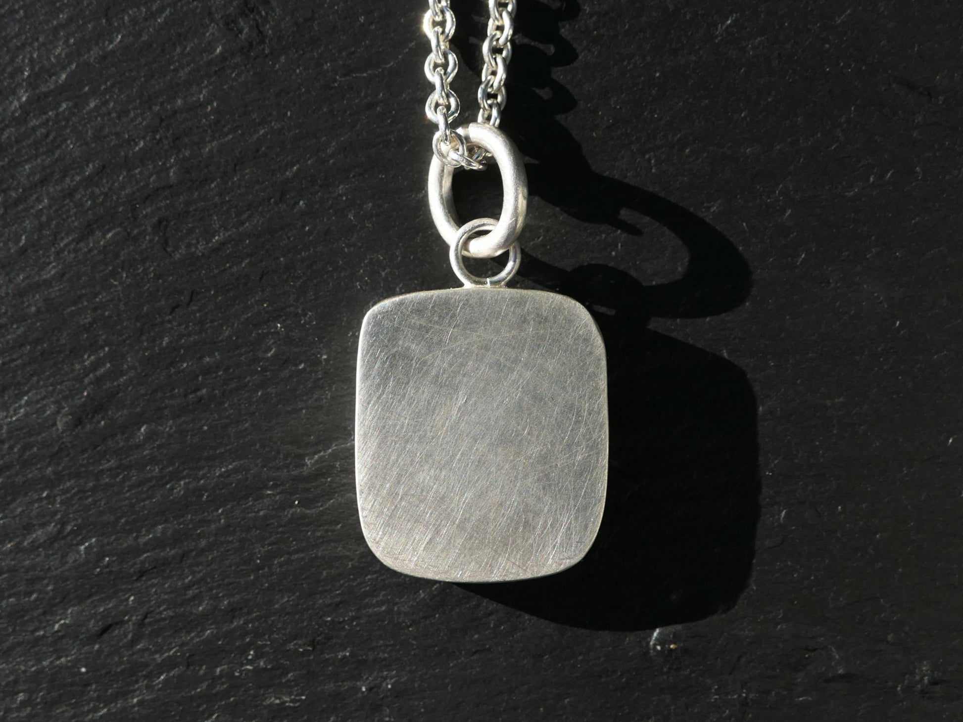 engraved turquoise pendant