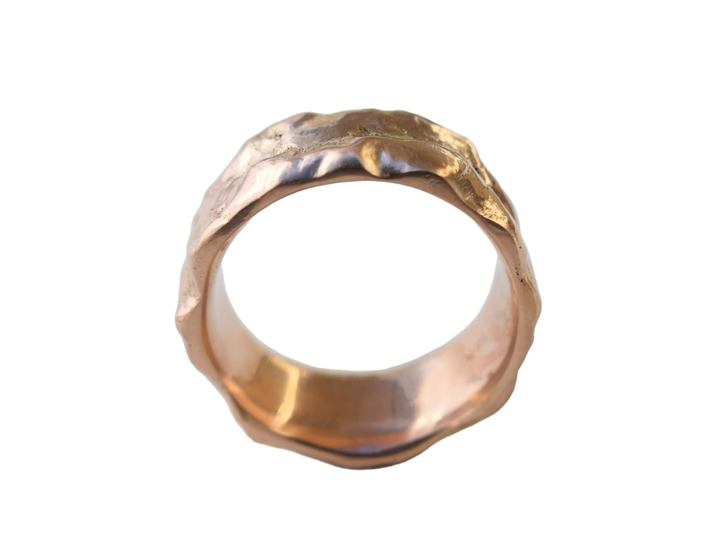 molten gold wedding ring on white background