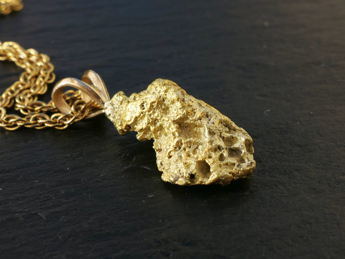 Genuine Natural Gold Nugget pendant in textured yellow gold with a porous, irregular shape and gold bail