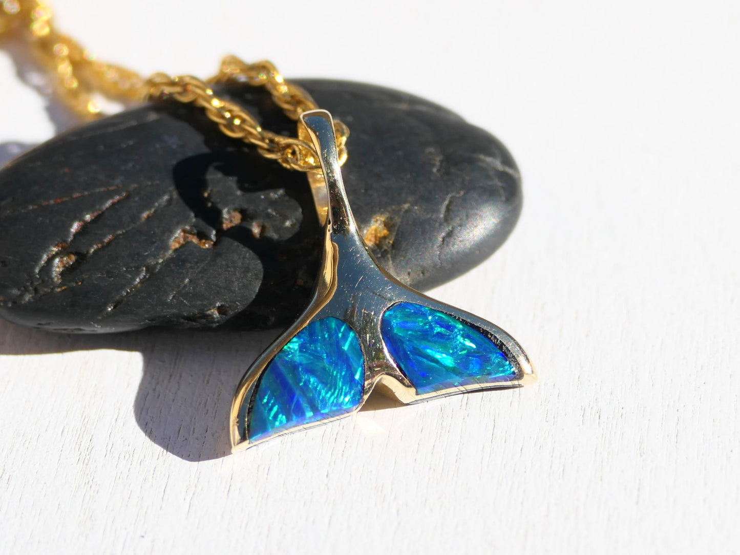 gold whale tail necklace with black opals