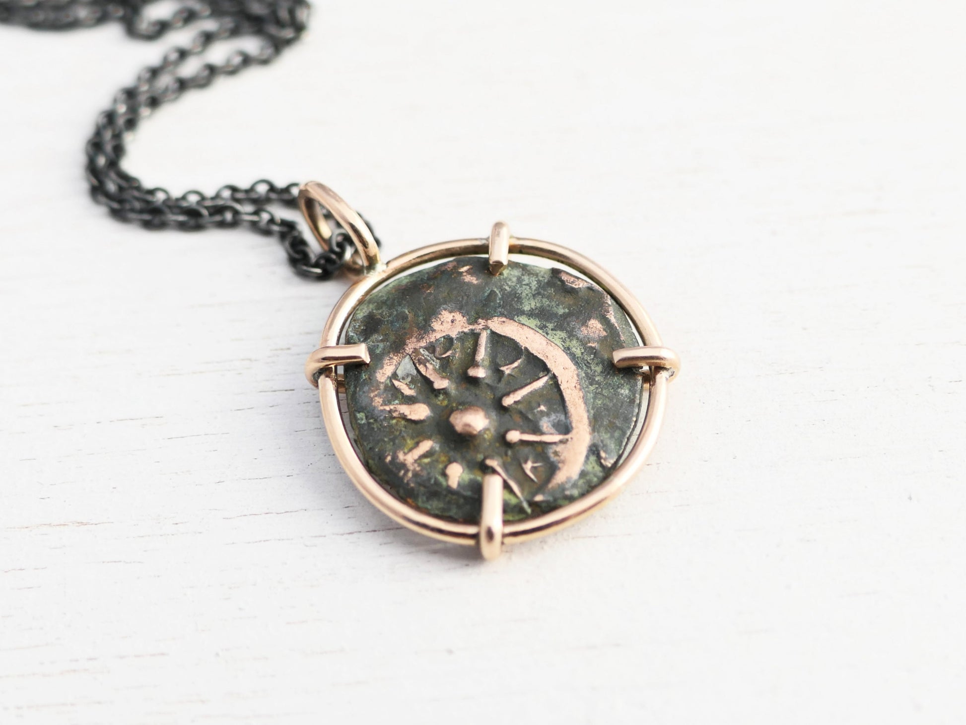 Authentic ancient Widows Mite coin pendant set in bronze with green and brown patina, 24mm length, displayed on a black background