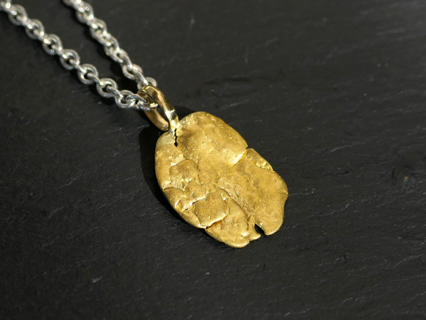Natural gold nugget pendant with sterling silver chain and 18k gold bail.