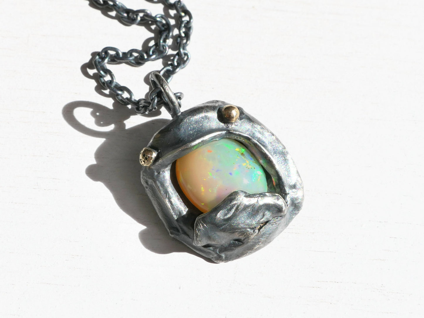 Ethiopian opal pendant necklace in sterling silver with 14k gold accents and rainbow play of color