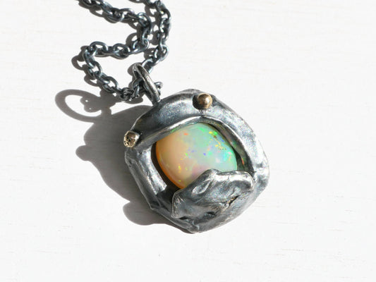 Ethiopian opal pendant necklace in sterling silver with 14k gold accents and rainbow play of color