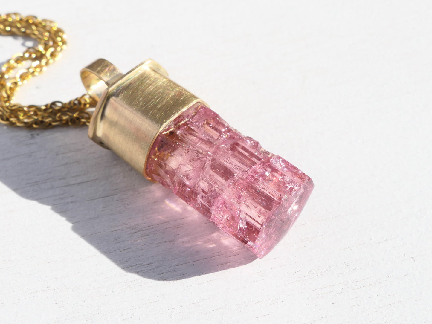 Large pink tourmaline crystal pendant set in 14K gold on a gold chain
