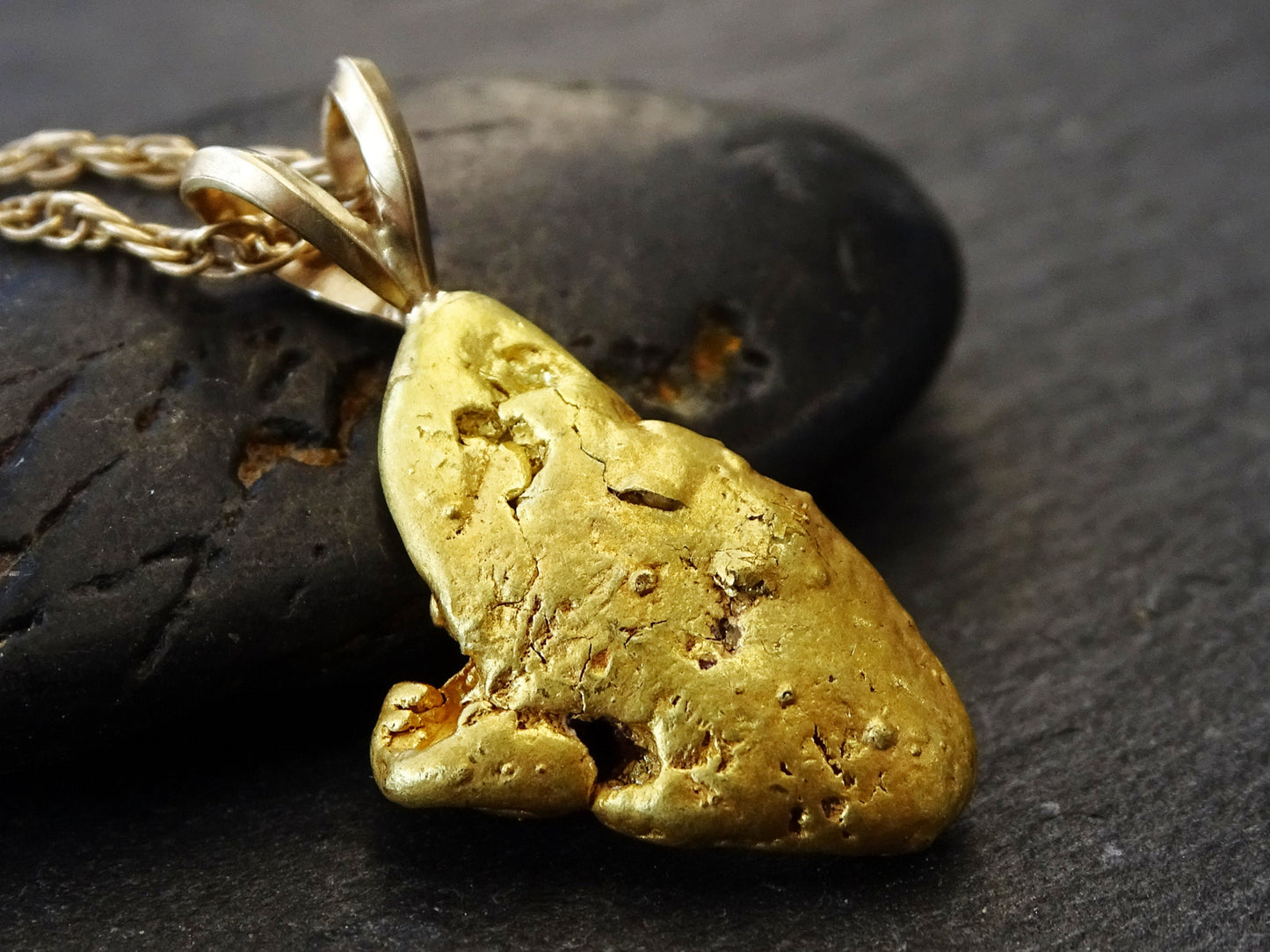 Real gold nugget pendant from Alaska.
&gt; overall pendant length is 24.5mm (0.96 inches) including the bail, weighing a total of 5.05 grams &gt; all natural gold nu